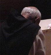 Inside the Abbey Church, monks keep vigil beside the body of their dead brother